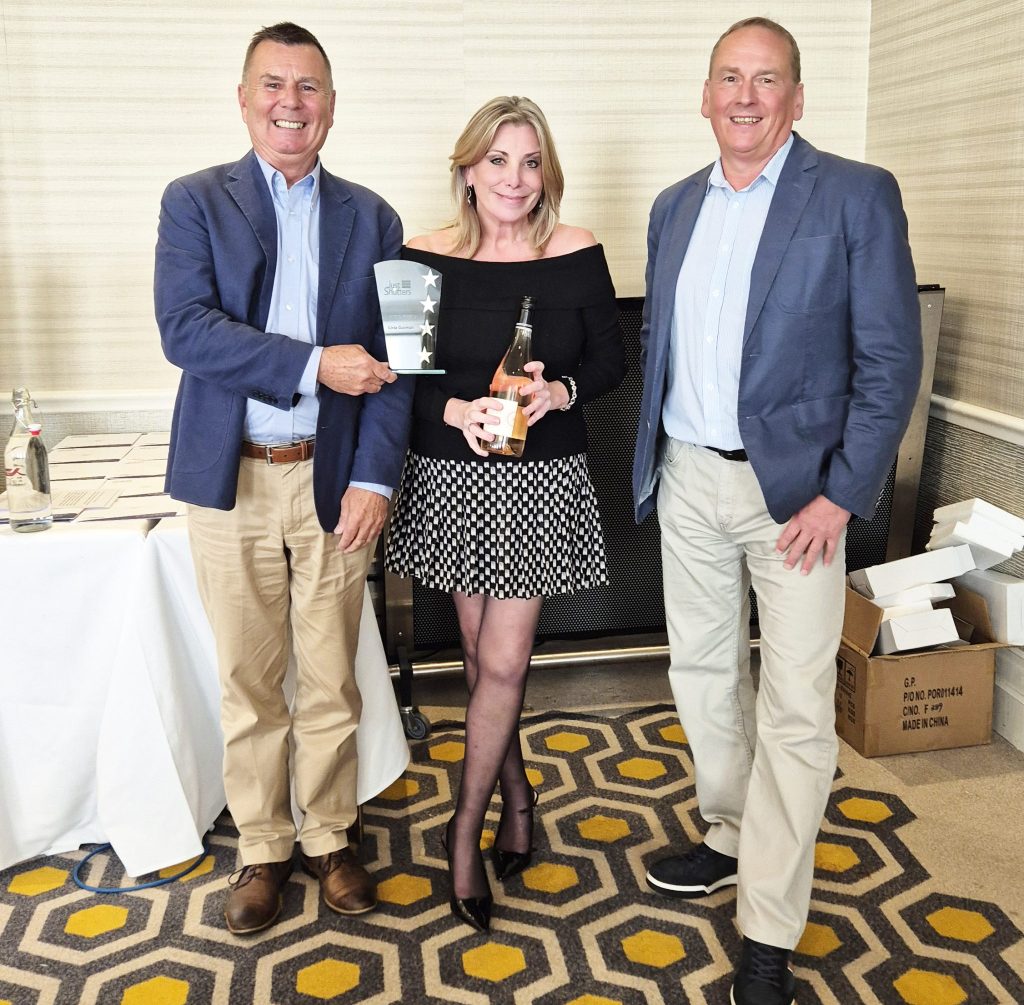 Livvy, Marketing Manager at Just Shutters, receiving the “Over and Above” award at the Just Shutters Conference 2026